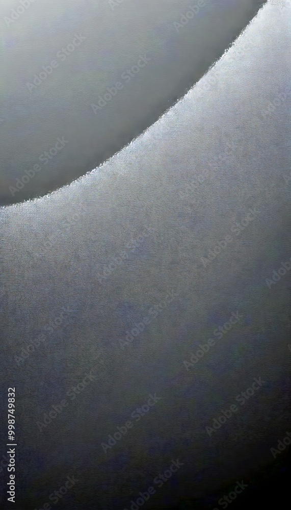 Poster a close-up view of a curved, metallic surface with a dark gray hue, creating a sense of depth and te