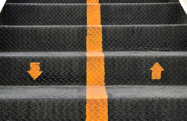 direction arrows up and down with dividing line on metal diamond plate stair