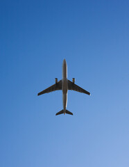 Commercial Airplane Ascending Against Clear Blue Sky - Modern Air Travel and Transportation