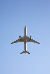 Commercial Airplane Ascending Against Clear Blue Sky - Modern Air Travel and Transportation
