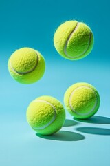 A bright tennis ball flies in the air against a light blue background