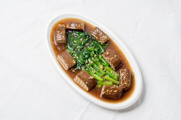 Stir-fried black tofu with Chinese kale