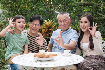 Happy Asian family Grand parent father mother and kid spending time in vacation