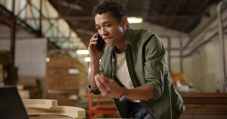 Man, call and factory with carpenter ordering supplies for inventory or restock with stress from supplier. Preparation, warehouse and conversation on cellphone with laptop for equipment order.