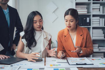Business Strategy Session:  Focused Collaboration: A diverse team of business professionals engages in a strategic meeting,  analyzing data and charts to develop innovative solutions.  