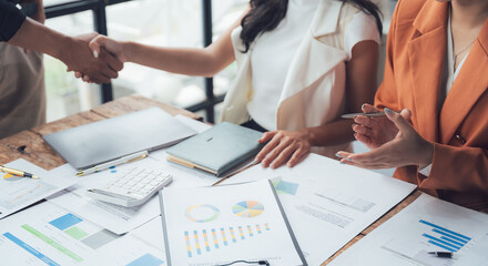 Business Deal: A close-up image of a handshake between two business professionals, signifying a...