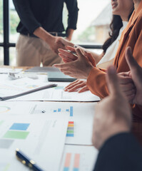 Business Meeting Applause: A close-up shot of a diverse group of business professionals clapping their hands in a meeting, showcasing the positive energy and camaraderie within their workplace.