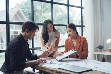 Modern Business Collaboration: A diverse team of professionals engrossed in a collaborative...