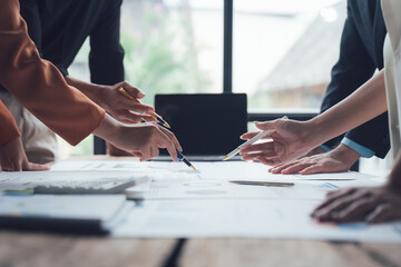 Collaboration and Strategy: Hands converge on a blueprint, pencils poised, indicating a collaborative brainstorming session fueled by shared vision and strategic planning.
