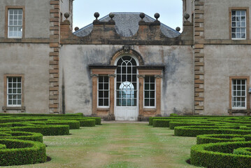 Obraz premium Facade of 18th Century Country House with Formal Garden in Public Park 