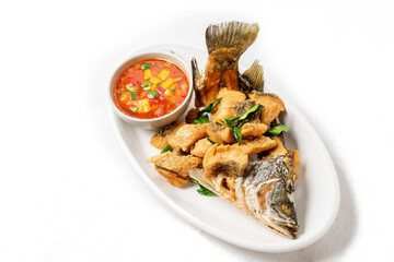 Fried sea bass on a white plate, looks delicious.