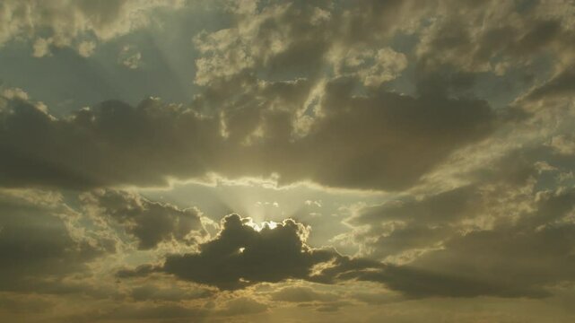 Sun rays through floating clouds. Time lapse
