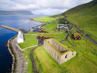 Naklejka premium Aerial view of historical Kirkjubøur village with ruins of the Magnus Cathedral and Saint Olav's Church, Faroe Island