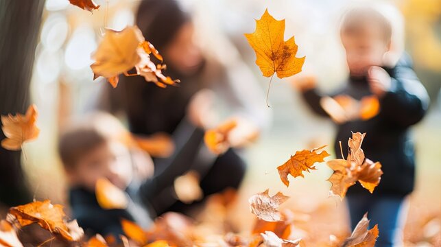 Family celebrating autumn season with orange fall leaves picking and doing an activity, blurred photo