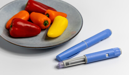  Ozempic Insulin injection pen for diabetics and weight loss on plate with vegetables