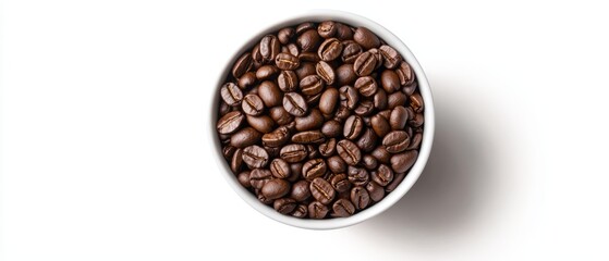 Fototapeta premium A white table holds a bowl filled with coffee beans and a cup of coffee