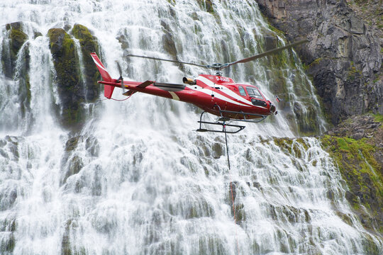 Airbus Helicopter H125 flying near a Dynjandi waterfall in the Westfjords region of Iceland