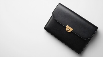 A sleek, minimalist black leather designer purse with gold accents, displayed on a clean white background, showcasing its smooth texture and structured design