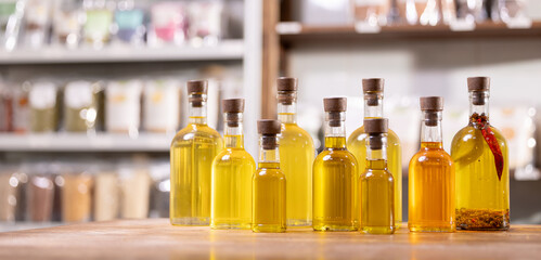 Production craft oil in bottles yellow sunflower on white blur background, banner