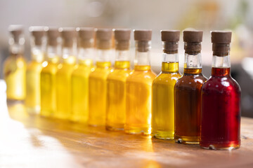 Set craft bottle with oil sunflower, black cumin, flax, cedar, castor, apricot, sesame, milk thistle, camelina, pumpkin seeds on blur background. Concept eco healthy food store