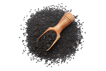 A wooden scoop filled with organic Black Sesame (Sesamum indicum) Seed powder, placed on a heap of Black Sesame seeds, isolated on a white background.