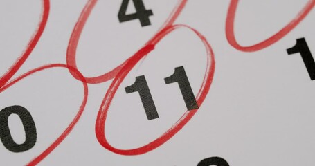 Close-up of a calendar date, the number 11 highlighted with a red circle, symbolizing an important or significant event. Close-Up Of Calendar Date Highlighted With Red Circle Marking Important Day