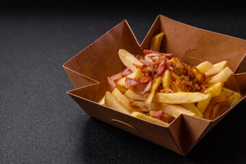 Crispy French fries with pieces of bacon, salt and spices