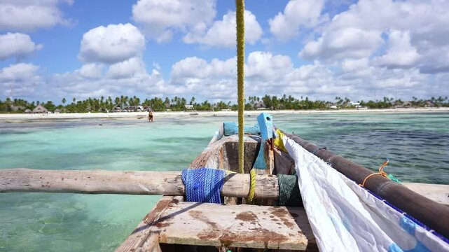 view from traditional wooden boat, near Nungwi beach in Zanzibar. African tropical island vacation, tourism destination in Tanzania. 