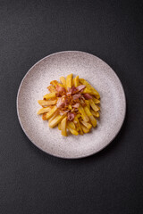 Crispy French fries with pieces of bacon, salt and spices