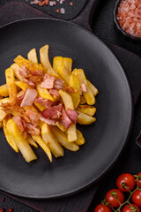 Crispy French fries with pieces of bacon, salt and spices