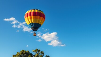 Naklejka premium A vibrant, stylized illustration of a majestic hot air balloon soaring through a clear blue sky, surrounded by gentle wisps of clouds and lush greenery below.