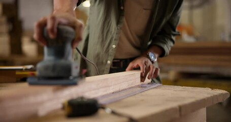 Carpenter, hands and sanding with electric tool for construction, furniture or project. Closeup of person smoothing wood with sandpaper in creative carpentry workshop for manufacturing, art and craft