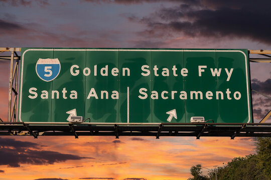View of Interstate 5 Golden State Freeway sign to Santa Ana or Sacramento in Los Angeles with sunset sky.