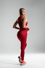 Young caucasian woman wearing headphones  active isolated on gray wall listening to music
Sexy fitness woman athletic girl