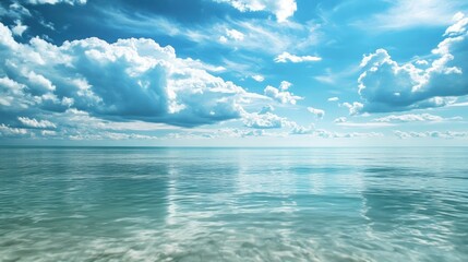 Obraz premium Blue Sky and Calm Ocean with White Clouds