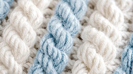 A close-up of soft, knitted wool featuring thick, cozy patterns in winter hues of white, cream, and pale blue, evoking warmth and comfort