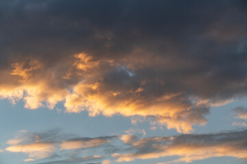 Sky background. Bright evening sunset sky with dramatic clouds.