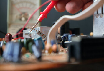 Technician is troubleshooting on the electronic circuit board. Testing industrial components....