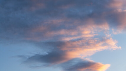 Sky background. Bright evening sunset sky with dramatic clouds.
