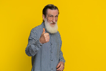 Like. Senior man raises thumbs up agrees with something or gives positive reply recommends...
