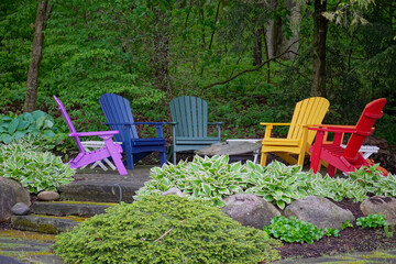 Group of colorful chairs in a garden