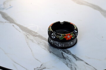 Ashtray for cigarettes and ash when smoking.