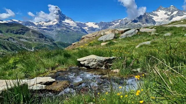 best hikes in Zermatt, the Five Lakes Trail (5-Seenweg) most famous hiking routs in Switzerland , Valais canton 4k hd video of streaming water  at Stellisee lake . view of Matterhorn mountain