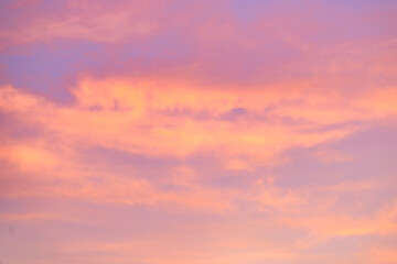 A beautiful sky tinted by the sun leaving vibrant shades of gold, pink, blue and multicolored. Clouds in the twilight evening and morning sky. Cloudy sky background in the evening, and during the day.