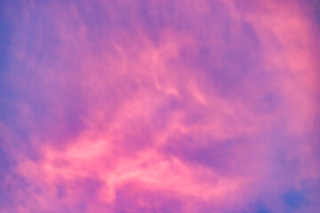 A beautiful sky tinted by the sun leaving vibrant shades of gold, pink, blue and multicolored. Clouds in the twilight evening and morning sky. Cloudy sky background in the evening, and during the day.
