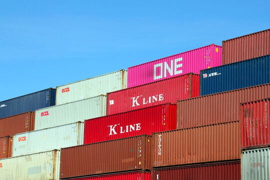 HAMBURG, GERMANY - JUNE 1, 2020: Stacked variegated shipping containers of OOCL, ONE, K-LINE and NYK  at the Port of Hamburg