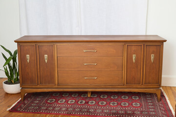 Vintage walnut dresser. Mid-century modern chest of drawers. Interior product photograph.