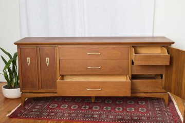 Vintage walnut dresser. Mid-century modern chest of drawers. Interior product photograph.