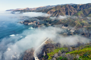 Beautiful scenery of Pacific Ocean coast along Highway 1 and Big Sur, wonderful aerial view of Bixby Bridge, sunset, sunrise, fog. Concept, travel, vacation, weekend