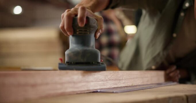 Man, carpenter and sanding woodwork in workshop with machine for production process and manufacturing. Handyman, closeup and hands with polishing beam in warehouse for diy restoration and remodeling